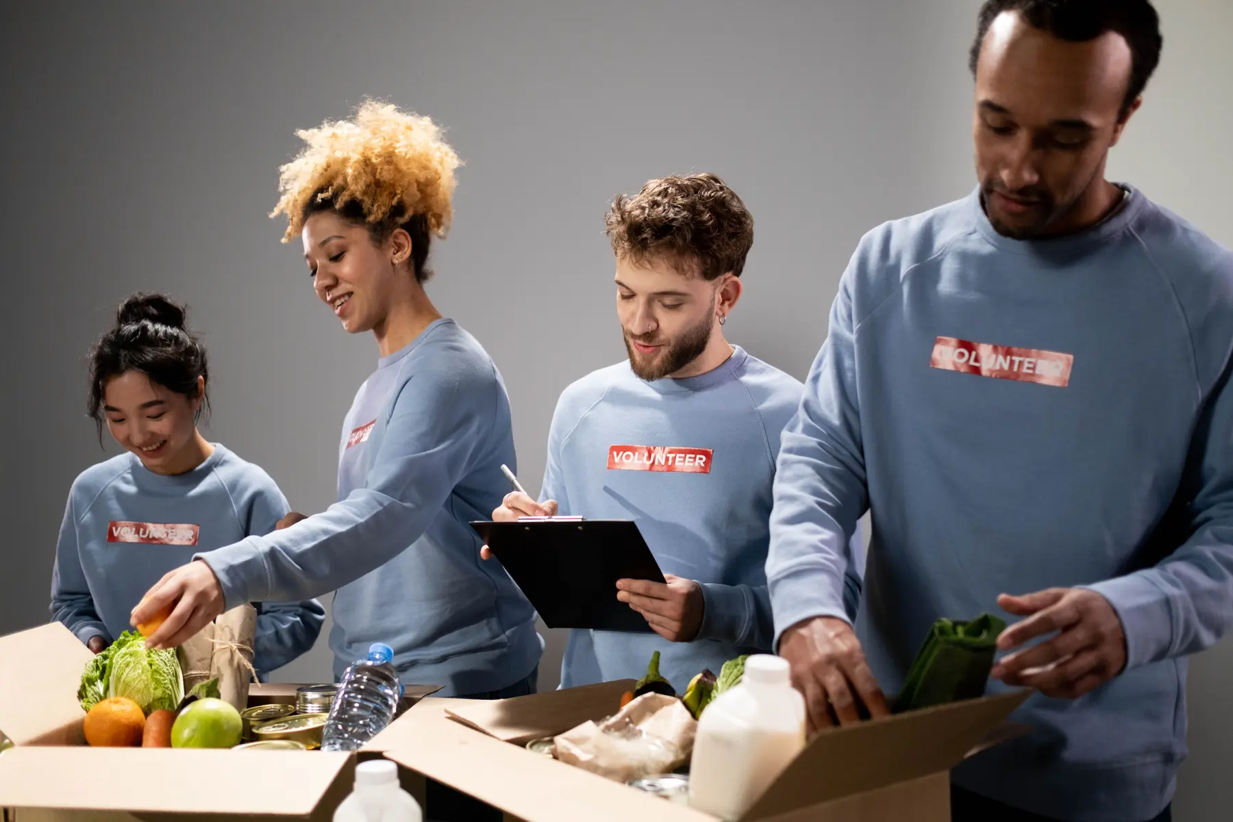 Volunteers packing food donations into boxes